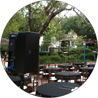 Image of a QSC speaker pointing toward tables