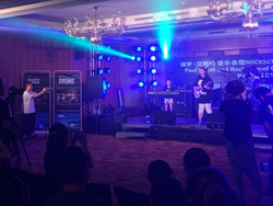 Band performing on stage at the Rock School Seminar and Concert in China, powered by the QSC TouchMix